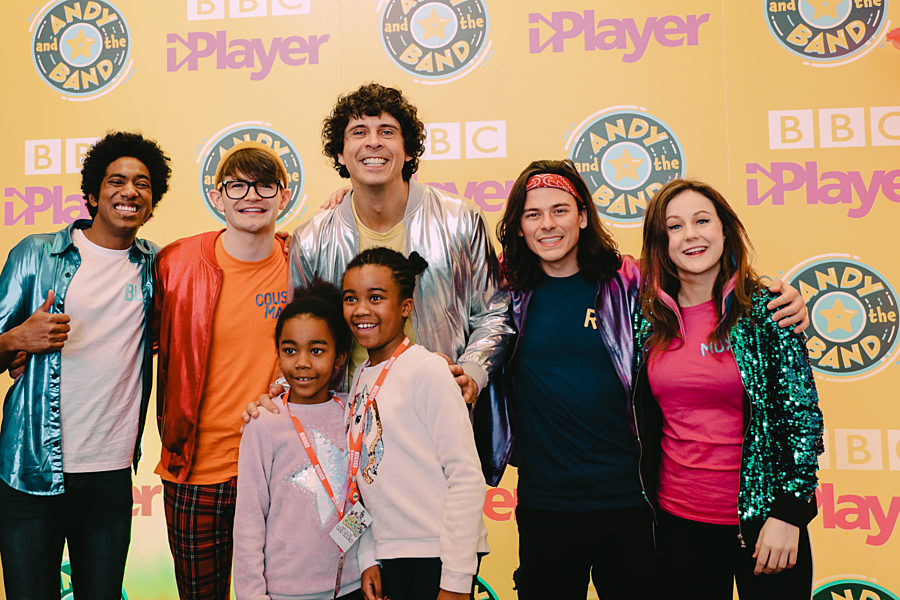 Andy & the band posing for photograph with young fans