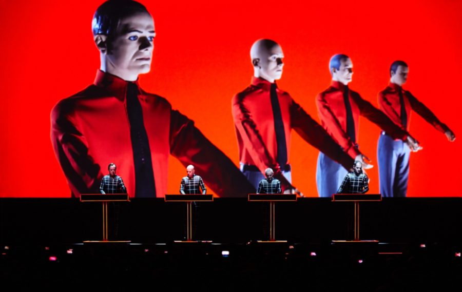 kraftwerk band performing on the bluedot main stage with a red background