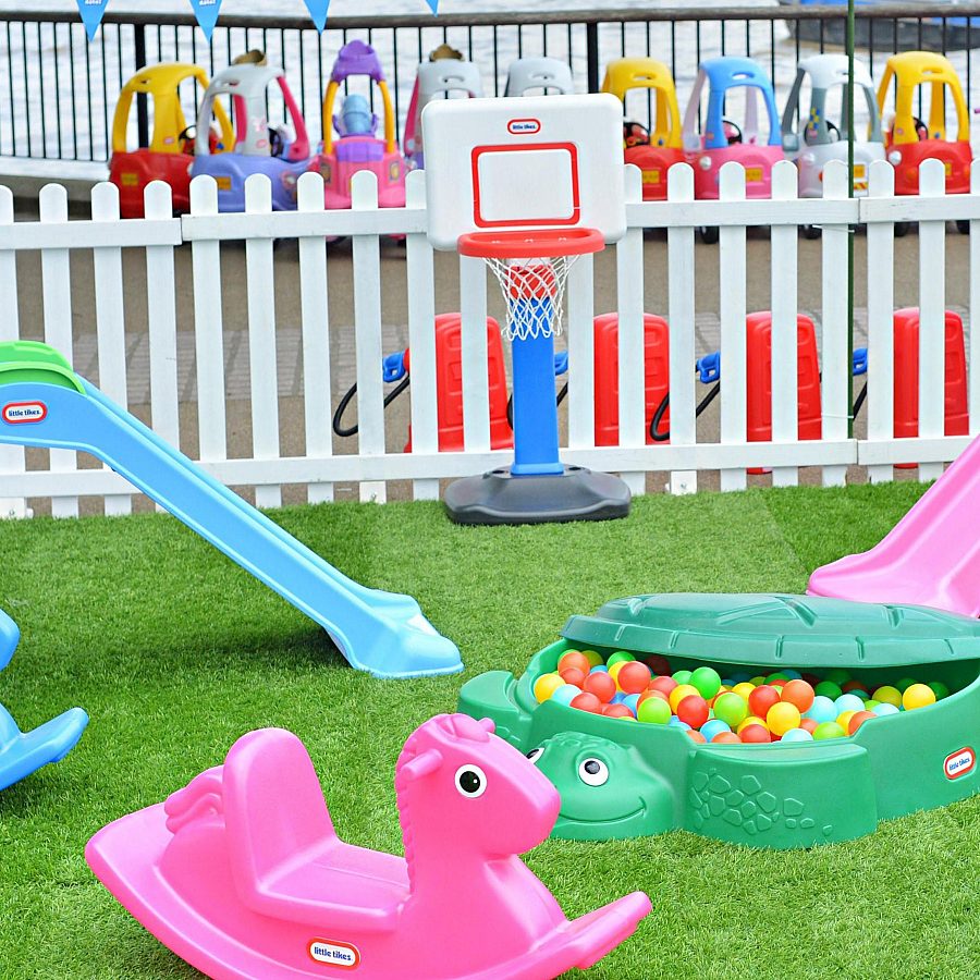 colourful childrens outdoor toys on green grass