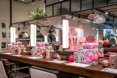 hair salon with giant mirrors and shelves filled with LOL surprise products