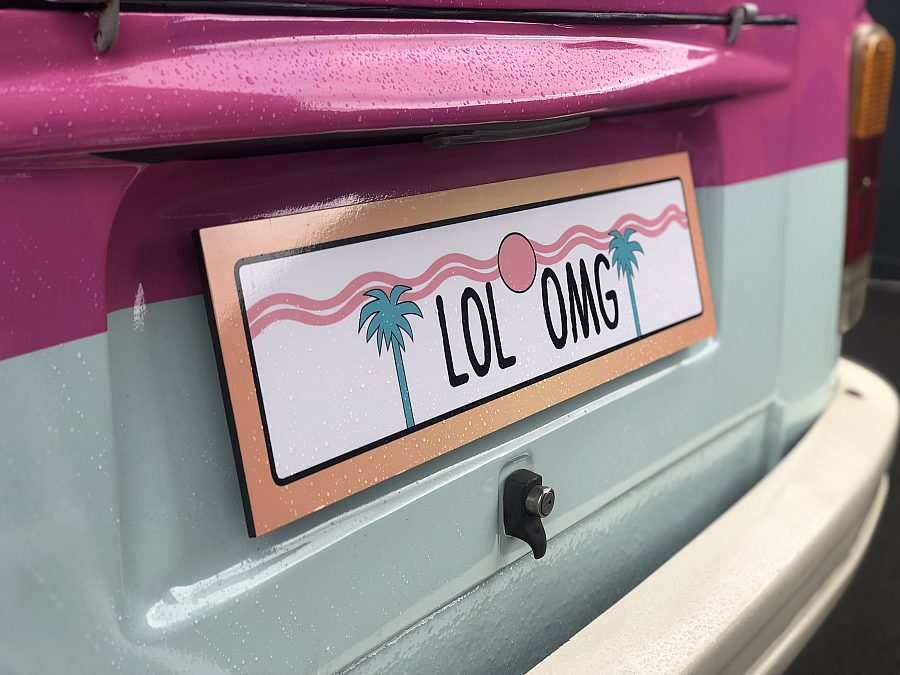 close up of a LOL Surprise branded number plate on a volksvagen campervan